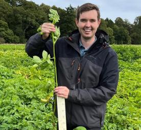 Dr James Price in a field of potatoes